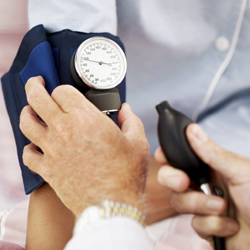 Pair of Human Hands Checking the Blood Pressure of a Patient --- Image by Royalty-Free/Corbis